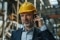 Manager wearing a helmet and speaking on the phone in a warehouse